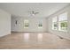 Bright living room with light wood floors, ceiling fan, and lots of natural light from the windows at 1763 Lipscomb Rd., Mullins, SC 29574