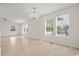 Bright living room with light wood floors, ceiling fan, chandelier, and lots of natural light from the windows at 1763 Lipscomb Rd., Mullins, SC 29574
