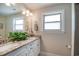 Modern bathroom featuring dual sinks, granite countertop, and ample natural light, creating a spa-like atmosphere at 193 Field Loop Rd., Georgetown, SC 29440