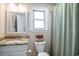 Well-lit bathroom with granite vanity, decorative mirror, and shower showcasing style and functionality at 193 Field Loop Rd., Georgetown, SC 29440