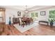 Elegant dining room with wood table, stylish decor, large window, and adjacent sliding glass doors to outdoor patio at 193 Field Loop Rd., Georgetown, SC 29440