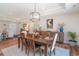Inviting dining area features a decorative light fixture and natural light from the large adjacent living area at 193 Field Loop Rd., Georgetown, SC 29440