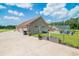 Exterior view showcasing the house, fenced yard, concrete patio, and detached garage at 193 Field Loop Rd., Georgetown, SC 29440