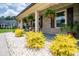 Inviting covered front porch with rocking chairs, hanging ferns, and decorative plants set against a brick facade at 193 Field Loop Rd., Georgetown, SC 29440
