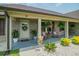 Charming covered porch featuring rocking chairs, potted plants, and a decorative wreath on the front door at 193 Field Loop Rd., Georgetown, SC 29440
