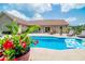 Beautiful pool area with lounge chairs, flowers, and outdoor dining showcasing backyard enjoyment at 193 Field Loop Rd., Georgetown, SC 29440