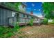 Backyard with wood deck, steps down to ground, with view of lush landscaping and trees at 2010 Ye Olde Kings Hwy., North Myrtle Beach, SC 29582