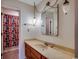 Bathroom featuring an ornate mirror, decorative light fixtures, and wood vanity, creating a unique aesthetic at 2010 Ye Olde Kings Hwy., North Myrtle Beach, SC 29582