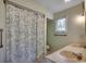 Bright bathroom featuring a double sink vanity and floral patterned shower curtain providing an airy feel at 2010 Ye Olde Kings Hwy., North Myrtle Beach, SC 29582