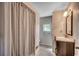 Bathroom featuring a striped shower curtain, a single sink vanity, and a modern light fixture at 2010 Ye Olde Kings Hwy., North Myrtle Beach, SC 29582
