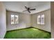 Bedroom with bright green carpet, ceiling fan and dual windows providing ample sunlight at 2010 Ye Olde Kings Hwy., North Myrtle Beach, SC 29582