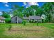 Exterior view of a cozy home with a lush green lawn and mature trees at 2010 Ye Olde Kings Hwy., North Myrtle Beach, SC 29582