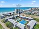 Aerial view of a beachside condo complex with pool and tennis courts at 206 2Nd Ave. N # 271, North Myrtle Beach, SC 29582