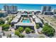Aerial view of a beachside condo complex with pool and tennis courts at 206 2Nd Ave. N # 271, North Myrtle Beach, SC 29582