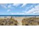 Sandy beach scene, with sea oats growing in the foreground, leading to the beautiful ocean at 206 2Nd Ave. N # 271, North Myrtle Beach, SC 29582
