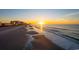 Sunrise over the ocean and shoreline condos, with a sandy beach in the foreground at 206 2Nd Ave. N # 271, North Myrtle Beach, SC 29582