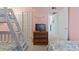 Comfortable bedroom with a TV atop a wooden dresser, a closet, and a glimpse into the hallway at 206 2Nd Ave. N # 271, North Myrtle Beach, SC 29582