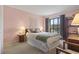 Inviting main bedroom featuring natural light, soft pink walls, and classic furnishings for a relaxing space at 206 2Nd Ave. N # 271, North Myrtle Beach, SC 29582