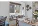 Bright dining area showcasing a cushioned window nook, a glass top dining table, and decorative wall hangings at 206 2Nd Ave. N # 271, North Myrtle Beach, SC 29582