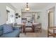 Bright dining area with a glass-top table that connects to the open kitchen and living room areas at 206 2Nd Ave. N # 271, North Myrtle Beach, SC 29582