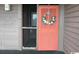 The front door entrance with screen door and decorative wreath at 206 2Nd Ave. N # 271, North Myrtle Beach, SC 29582