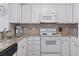 Cozy kitchen features white cabinetry and stainless appliances at 206 2Nd Ave. N # 271, North Myrtle Beach, SC 29582