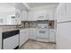 Charming kitchen with white cabinets, appliances, and granite countertops at 206 2Nd Ave. N # 271, North Myrtle Beach, SC 29582