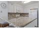 Kitchen featuring white cabinets, granite countertops and stainless appliances at 206 2Nd Ave. N # 271, North Myrtle Beach, SC 29582
