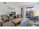 Comfortable living area featuring a blue sofa, entertainment center, and sliding doors to the patio at 206 2Nd Ave. N # 271, North Myrtle Beach, SC 29582