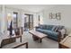 Comfortable living room with a blue sofa, patio access, and eclectic decor, offering a bright and airy feel at 206 2Nd Ave. N # 271, North Myrtle Beach, SC 29582