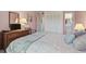 Cozy main bedroom features soft pink walls, a TV, and an ensuite bathroom at 206 2Nd Ave. N # 271, North Myrtle Beach, SC 29582
