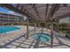 Relaxing pool area featuring a spa, trellis roof, and clear, inviting water at 206 2Nd Ave. N # 271, North Myrtle Beach, SC 29582