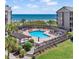 Oceanfront community pool area with a wooden boardwalk leading to the beach at 206 2Nd Ave. N # 271, North Myrtle Beach, SC 29582