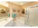 Bathroom featuring tile floors, double sink vanity, soaking tub with shower, neutral paint and nautical decor at 2241 Waterview Dr. # 315, North Myrtle Beach, SC 29582