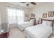 Well-lit bedroom with a ceiling fan, two twin beds, neutral walls, and ample natural light at 2241 Waterview Dr. # 315, North Myrtle Beach, SC 29582
