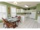 Bright kitchen and dining area with white cabinets, tiled floors, and a view of the appliances at 2241 Waterview Dr. # 315, North Myrtle Beach, SC 29582
