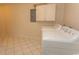 Bright laundry room featuring modern appliances and convenient upper cabinet storage at 2241 Waterview Dr. # 315, North Myrtle Beach, SC 29582