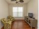 Comfortable living room features hardwood floors, ceiling fan, two chairs, console table and natural light from the windows at 2241 Waterview Dr. # 315, North Myrtle Beach, SC 29582
