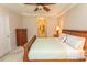 Carpeted bedroom boasts a ceiling fan, a decorative bed, and an open doorway to the bathroom at 2241 Waterview Dr. # 315, North Myrtle Beach, SC 29582