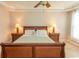 Bedroom features a decorative bed, two windows, ceiling fan, night stands and a neutral paint scheme at 2241 Waterview Dr. # 315, North Myrtle Beach, SC 29582