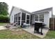 Backyard features a sunroom, a patio with lounge chairs, and a grill, perfect for outdoor entertaining at 233 Oak Lea Dr., Conway, SC 29526