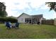 The backyard includes a fire pit, outdoor seating, a screened-in porch, and well-maintained lawn at 233 Oak Lea Dr., Conway, SC 29526
