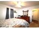 Bright bedroom with natural light, dark curtains, a wooden dresser, and easy access to the hallway at 233 Oak Lea Dr., Conway, SC 29526