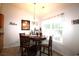 Cozy dining area with a wooden table set, chandelier lighting, and a large window for natural light at 233 Oak Lea Dr., Conway, SC 29526