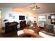 Open-concept living room with a large TV, hardwood floors, and plenty of natural light at 233 Oak Lea Dr., Conway, SC 29526