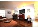 Well-lit living room featuring hardwood floors, entertainment center with a fireplace, and ample seating at 233 Oak Lea Dr., Conway, SC 29526