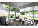 Relaxing sunroom with comfortable chairs, overlooking the backyard with a grill and seating area at 233 Oak Lea Dr., Conway, SC 29526