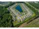 Aerial view of a residential area with a pond, highway, and bordered by trees at 2492 Goldfinch Dr., Myrtle Beach, SC 29577