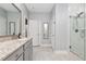 Modern bathroom features a spacious vanity, large mirror, and a walk-in shower at 2492 Goldfinch Dr., Myrtle Beach, SC 29577