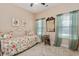 Bright bedroom features a daybed, soft carpet, and views out large windows at 2492 Goldfinch Dr., Myrtle Beach, SC 29577